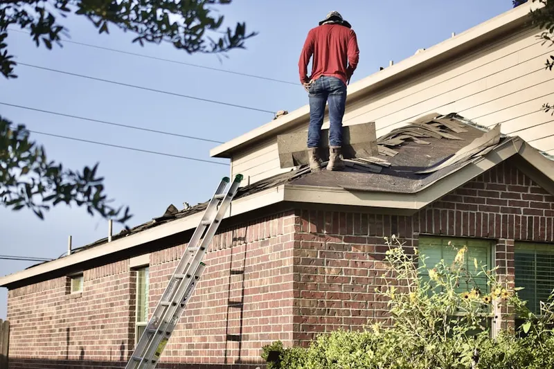 Professional roofer working on a residential roof in Fisher Island